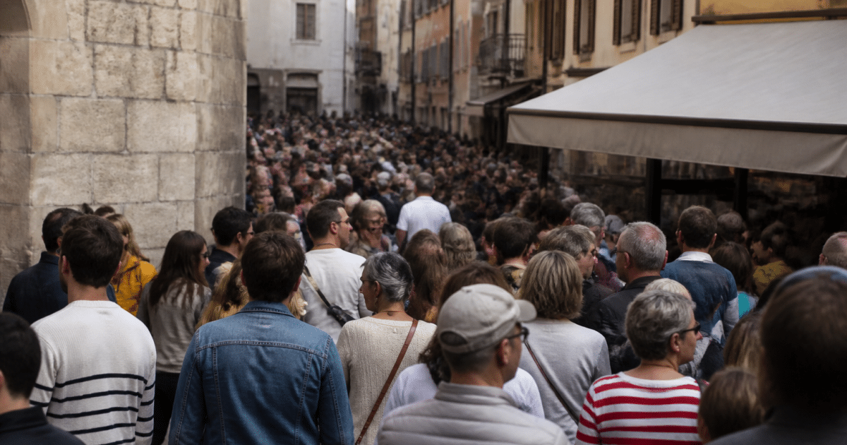 Foule de personnes debout rassemblees dans rue urbaine